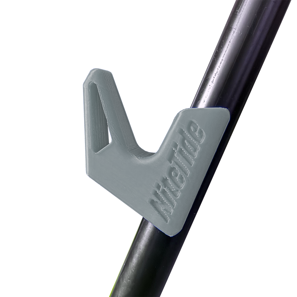 A grey side rest clip attached to a tripod leg, designed to hold a fishing rod.