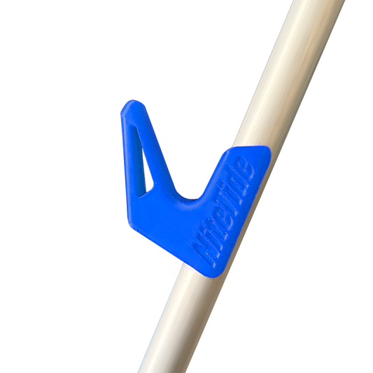 A blue side rest clip attached to a tripod leg, designed to hold a fishing rod.