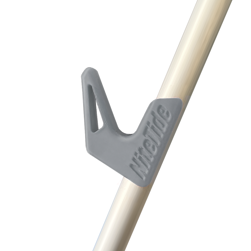 A grey side rest clip attached to a tripod leg, designed to hold a fishing rod.