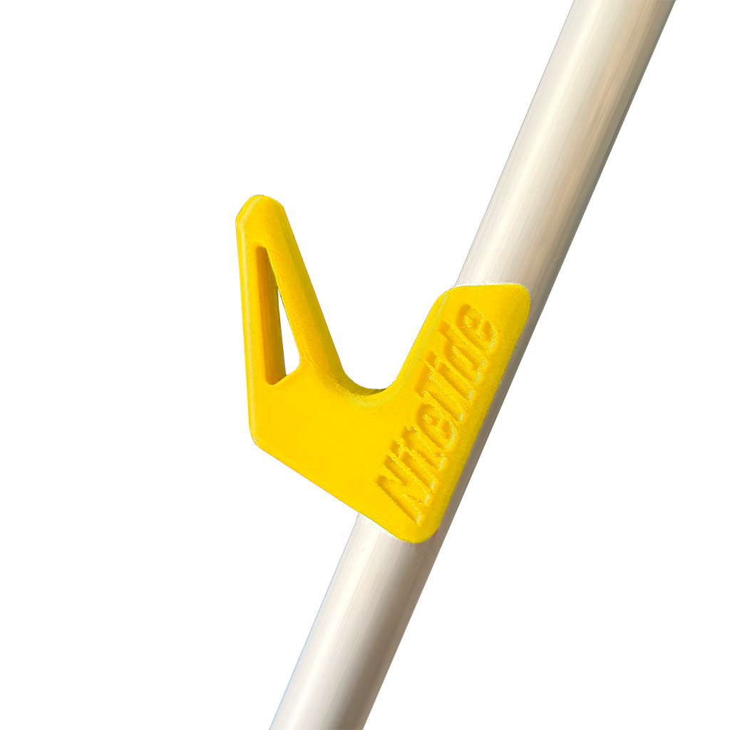 A yellow side rest clip attached to a tripod leg, designed to hold a fishing rod.